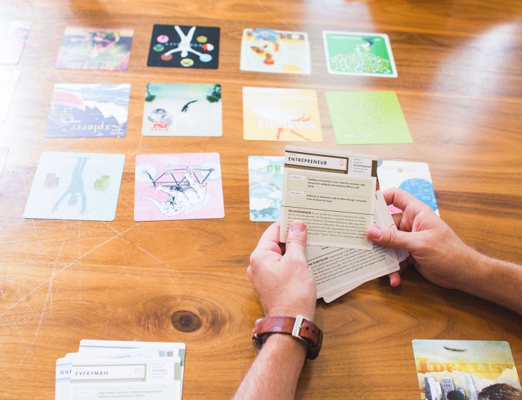 workshop participant holding multiple archetype cards for business personas