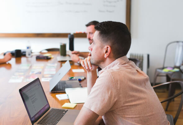 Ryan, company partner, sat at laptop looking pensive